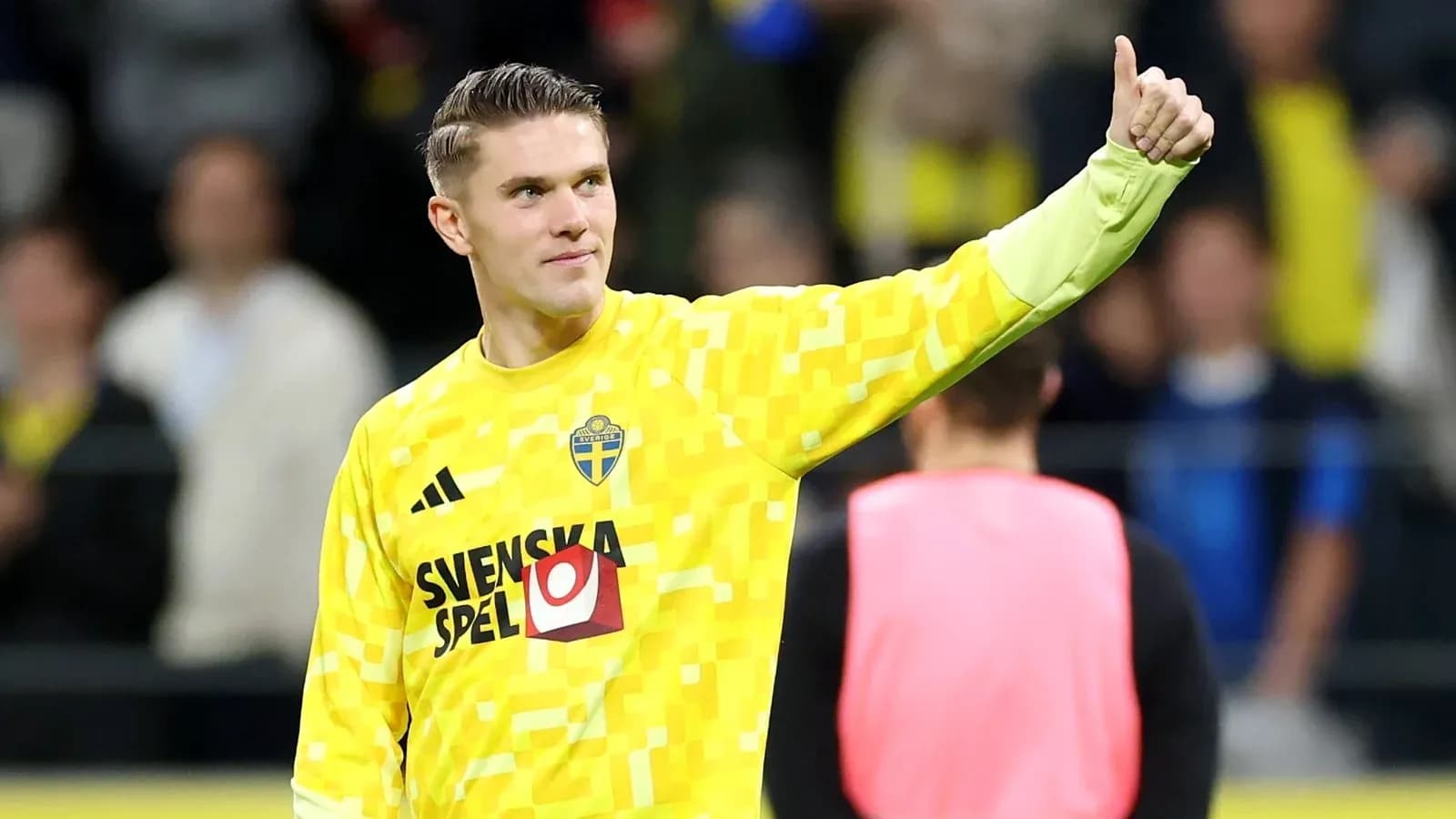 Goalkeeper in yellow kit giving a thumbs up