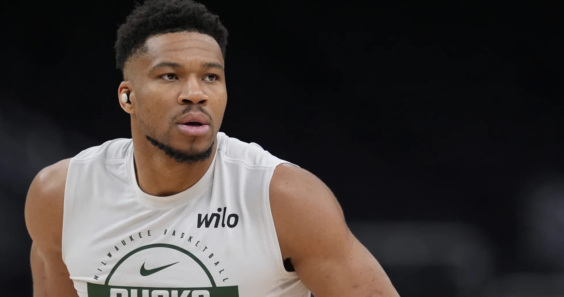 Basketball player training in Milwaukee Bucks jersey