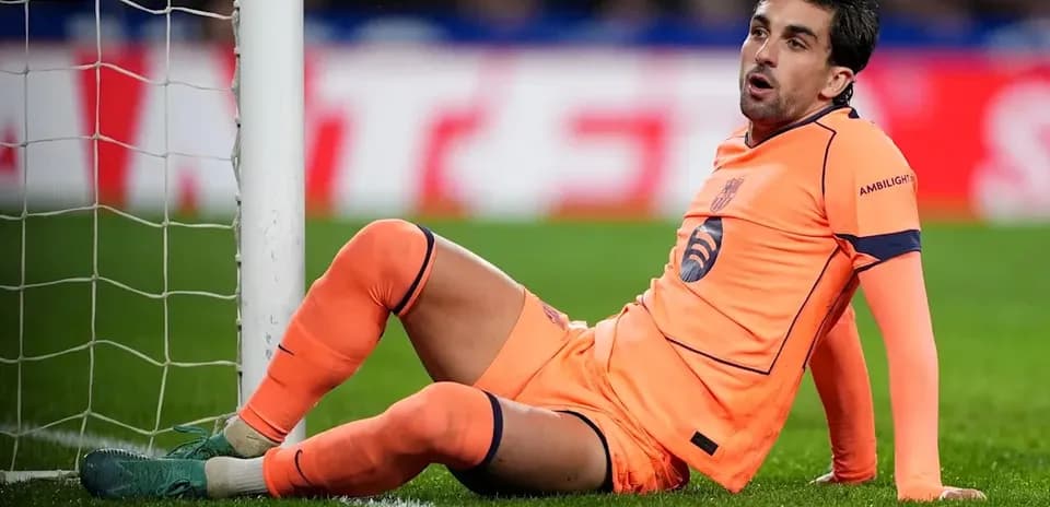 Player sitting on the ground near goalpost