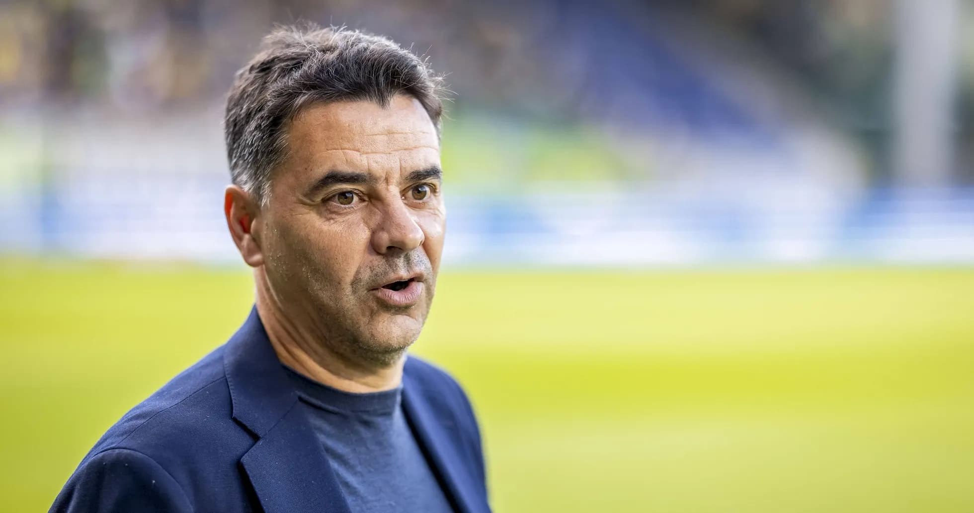 Manager speaking on the pitch before match