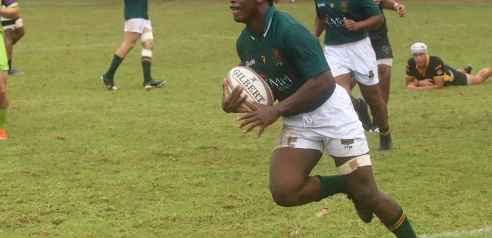Rugby player running with ball during match
