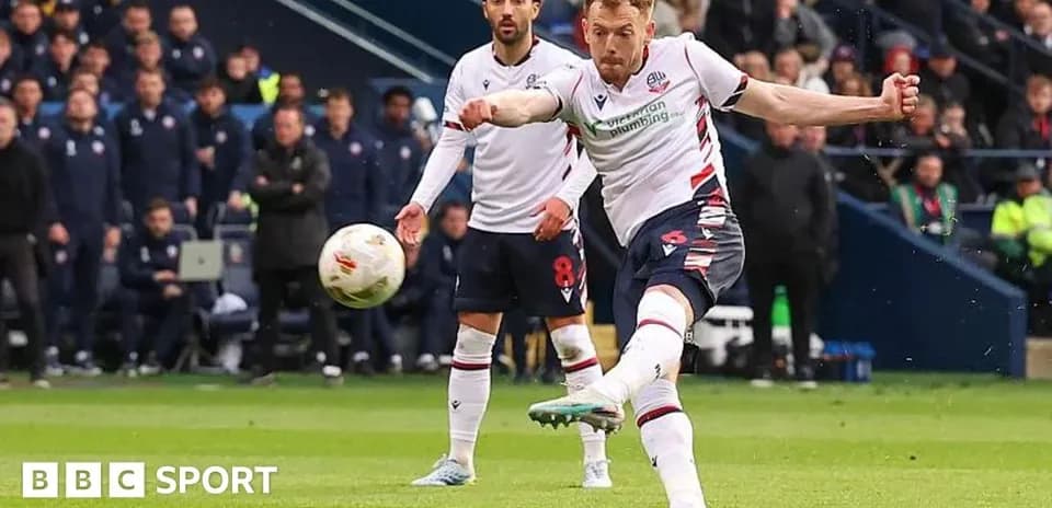 Bolton player taking a penalty kick during match