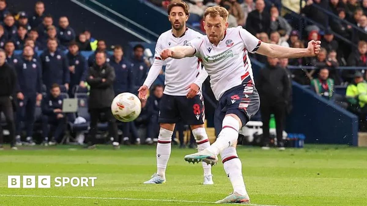 Bolton player taking a penalty kick during match