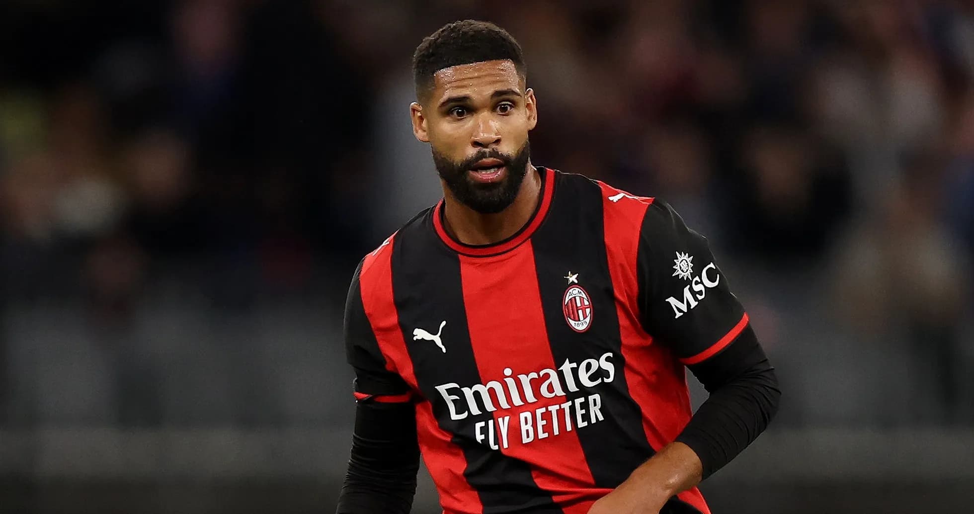 Futbolçu AC Milan formasında meydançada hərəkət edir