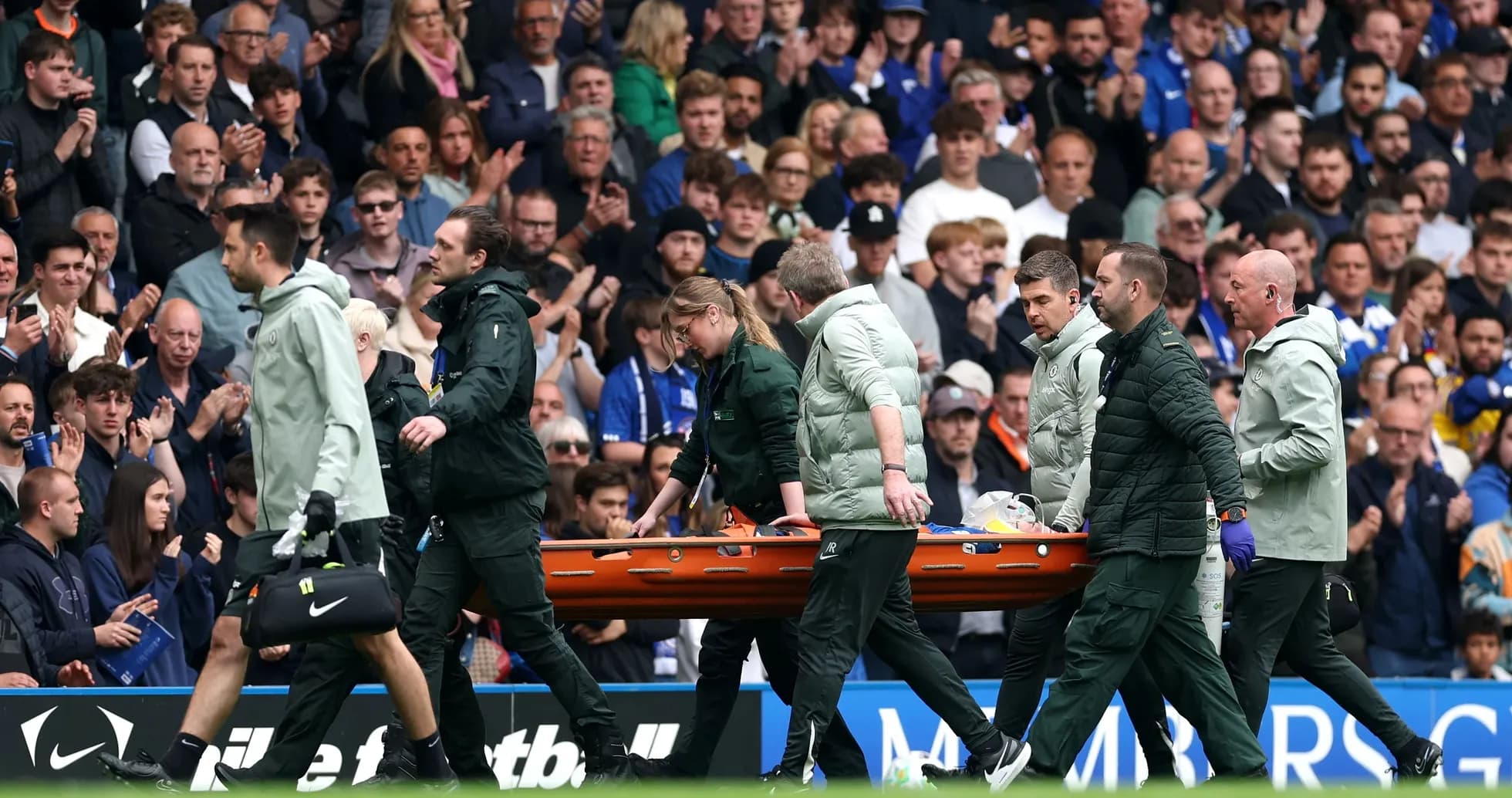 Medical staff carrying stretcher off the field