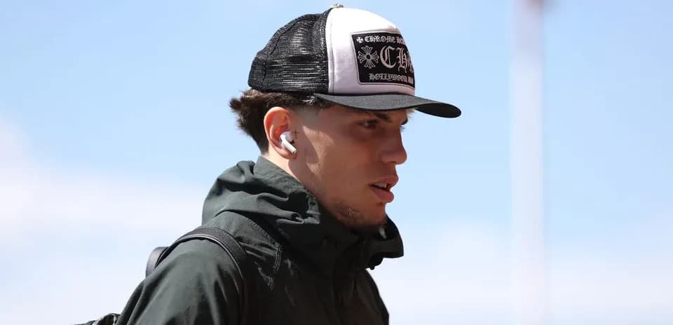 Athlete wearing a cap and earphones walking