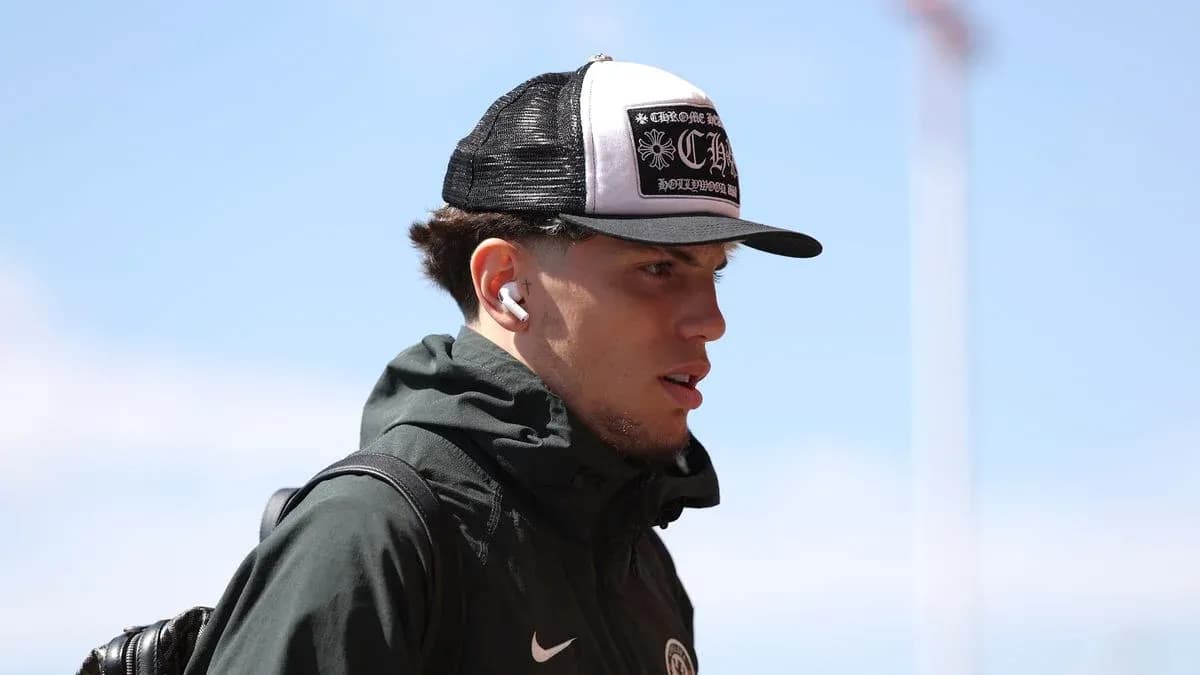 Athlete wearing a cap and earphones walking