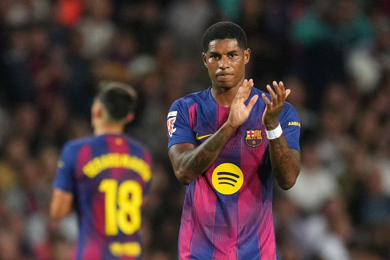 Barcelona player applauding during match