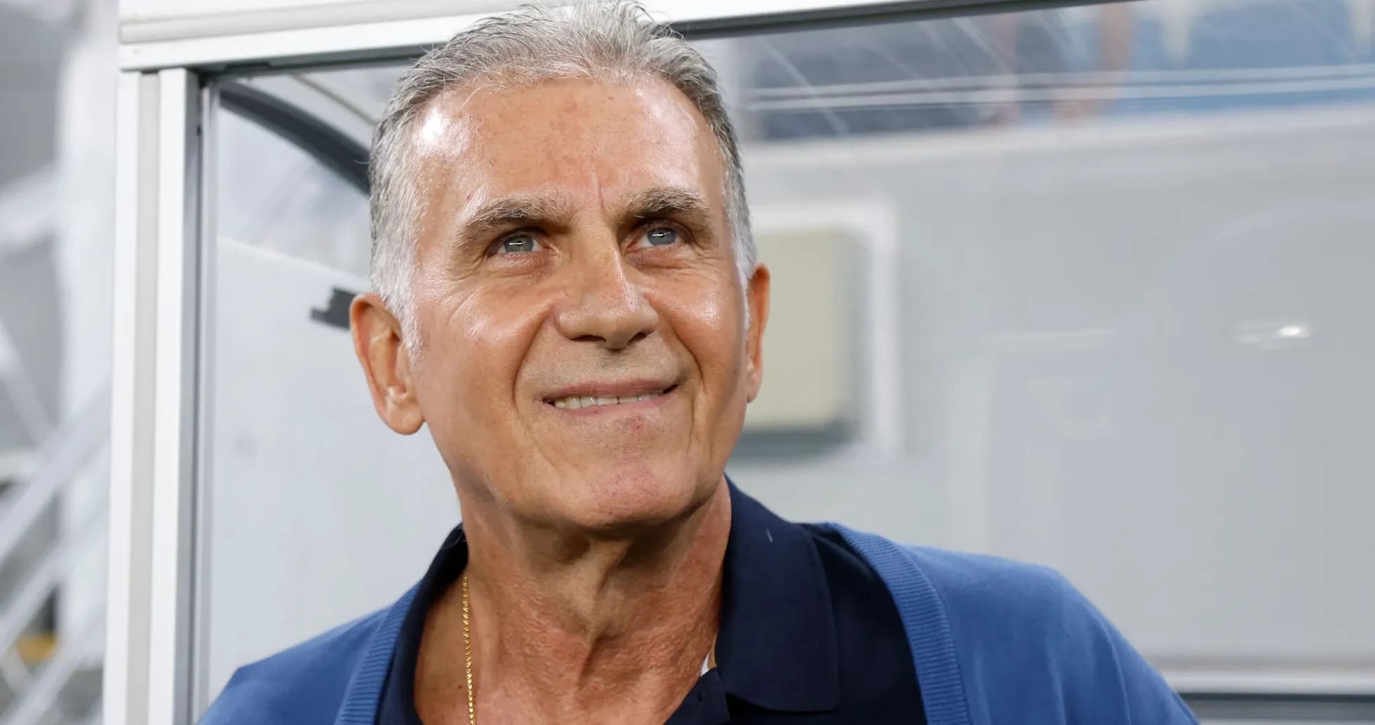 Coach smiling from the technical area during match