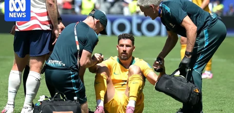 Goalkeeper receiving medical attention on the field