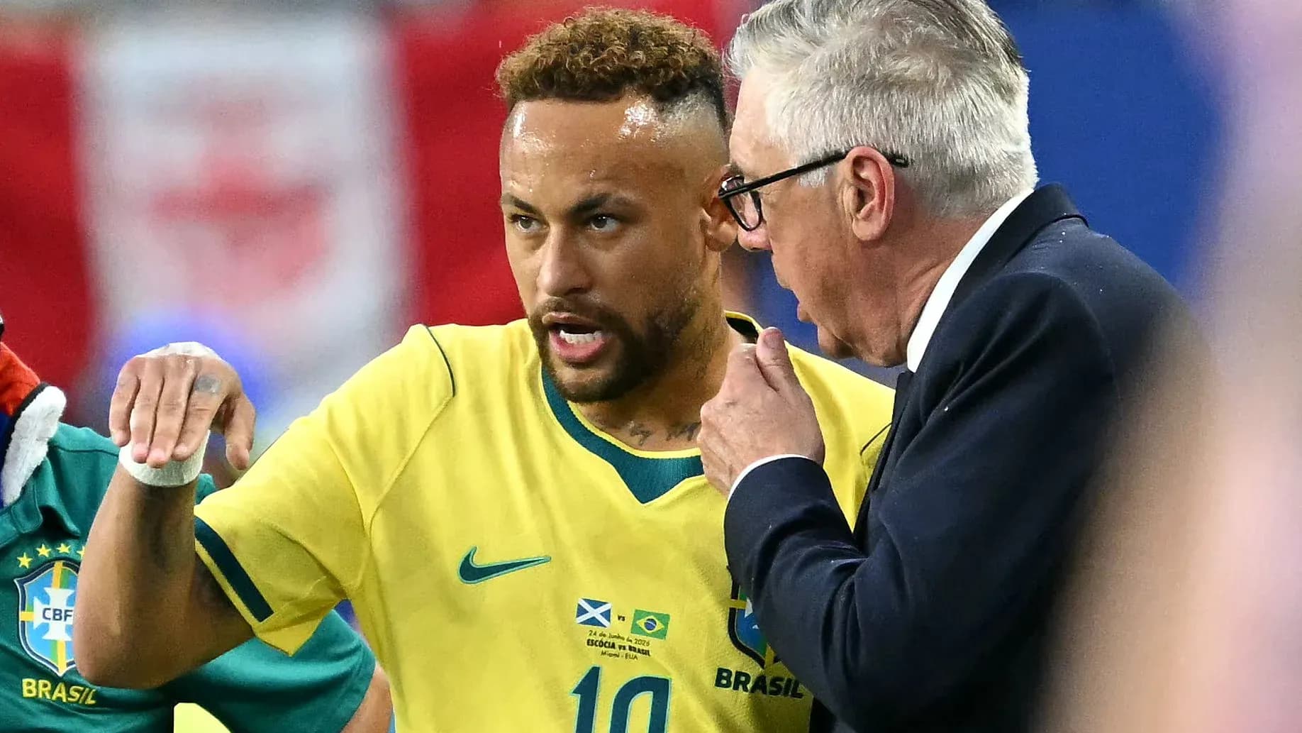 Neymar conversing with coach during a match