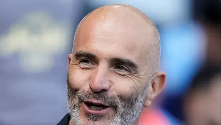 Coach smiling during a pre-match event