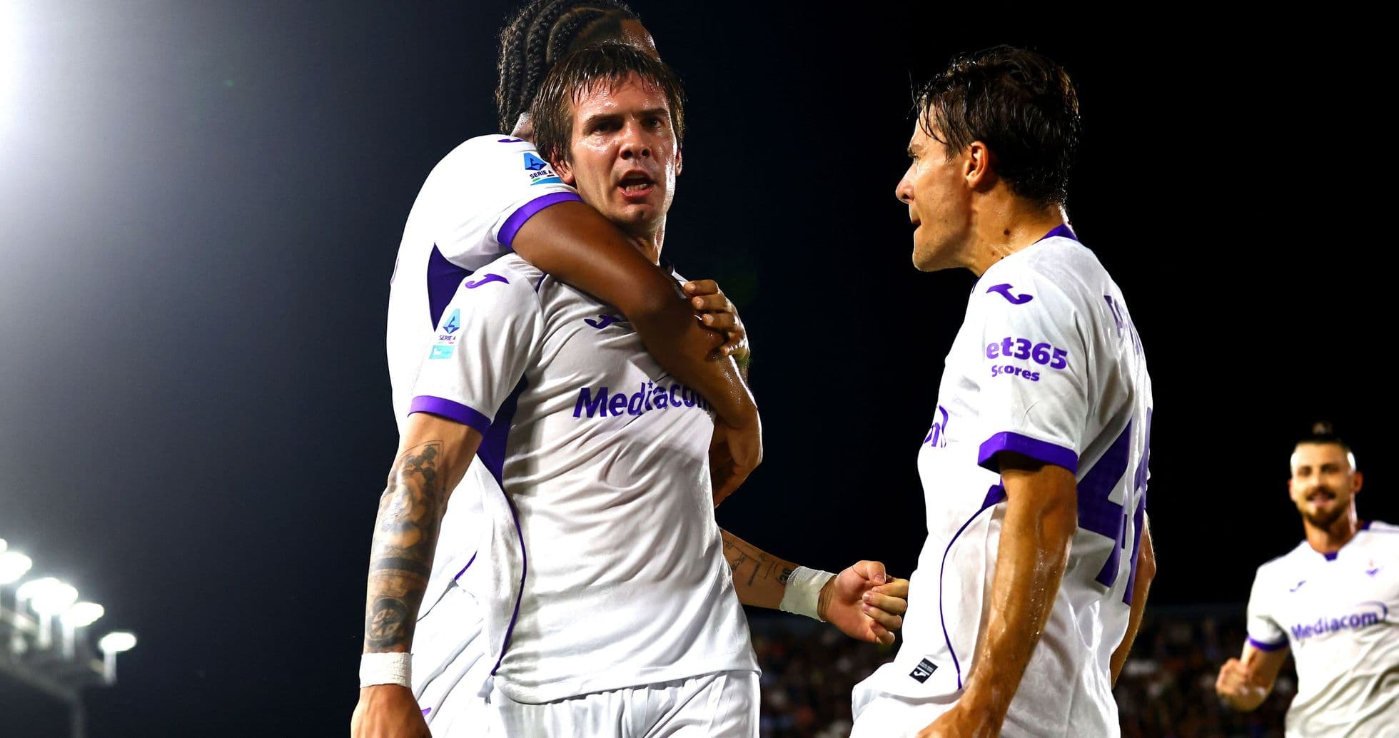 Fiorentina players celebrating a goal on the field