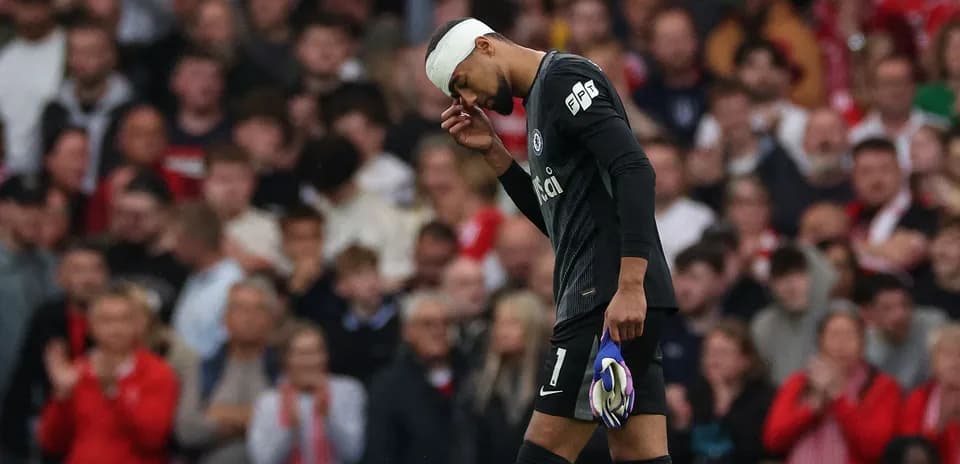 Goalkeeper with bandaged head walking off field