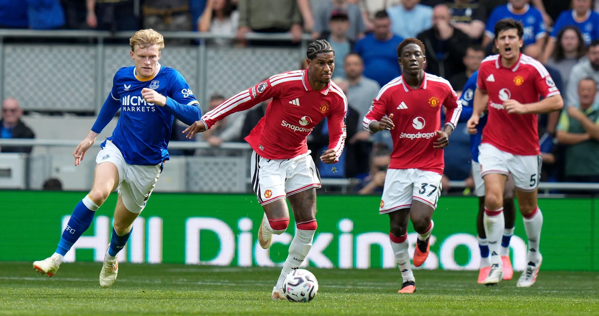 Manchester United players sprinting during a match