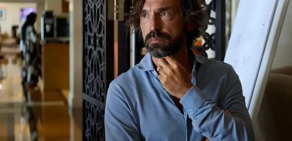 Man in a blue shirt standing in a room
