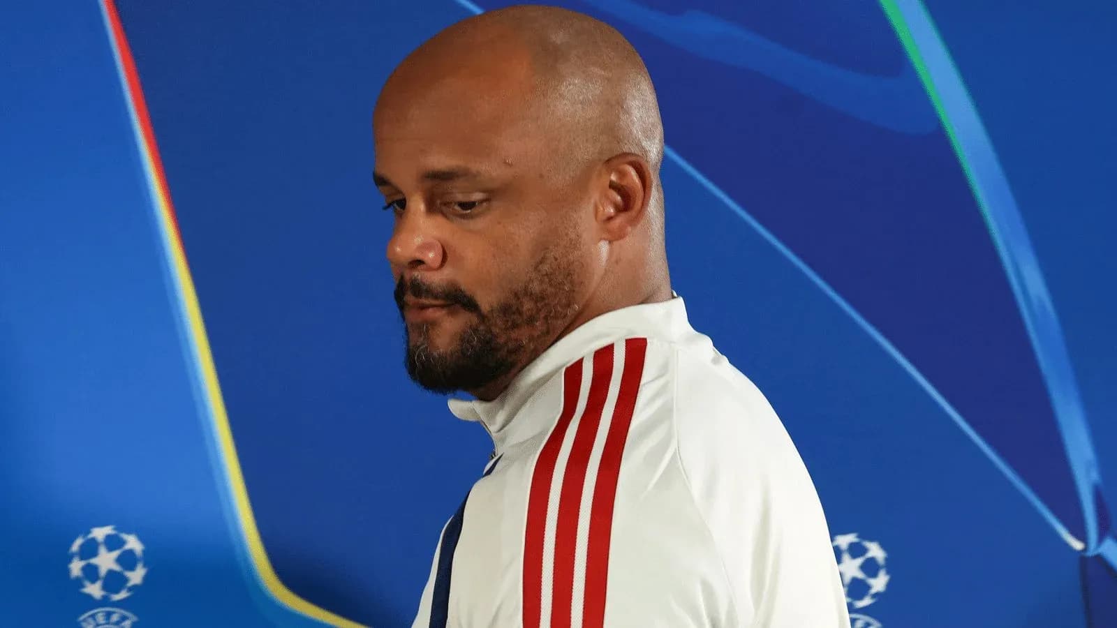 Men's football manager at press conference backdrop
