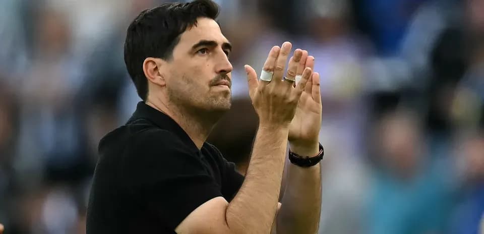 Coach applauding fans in the stadium