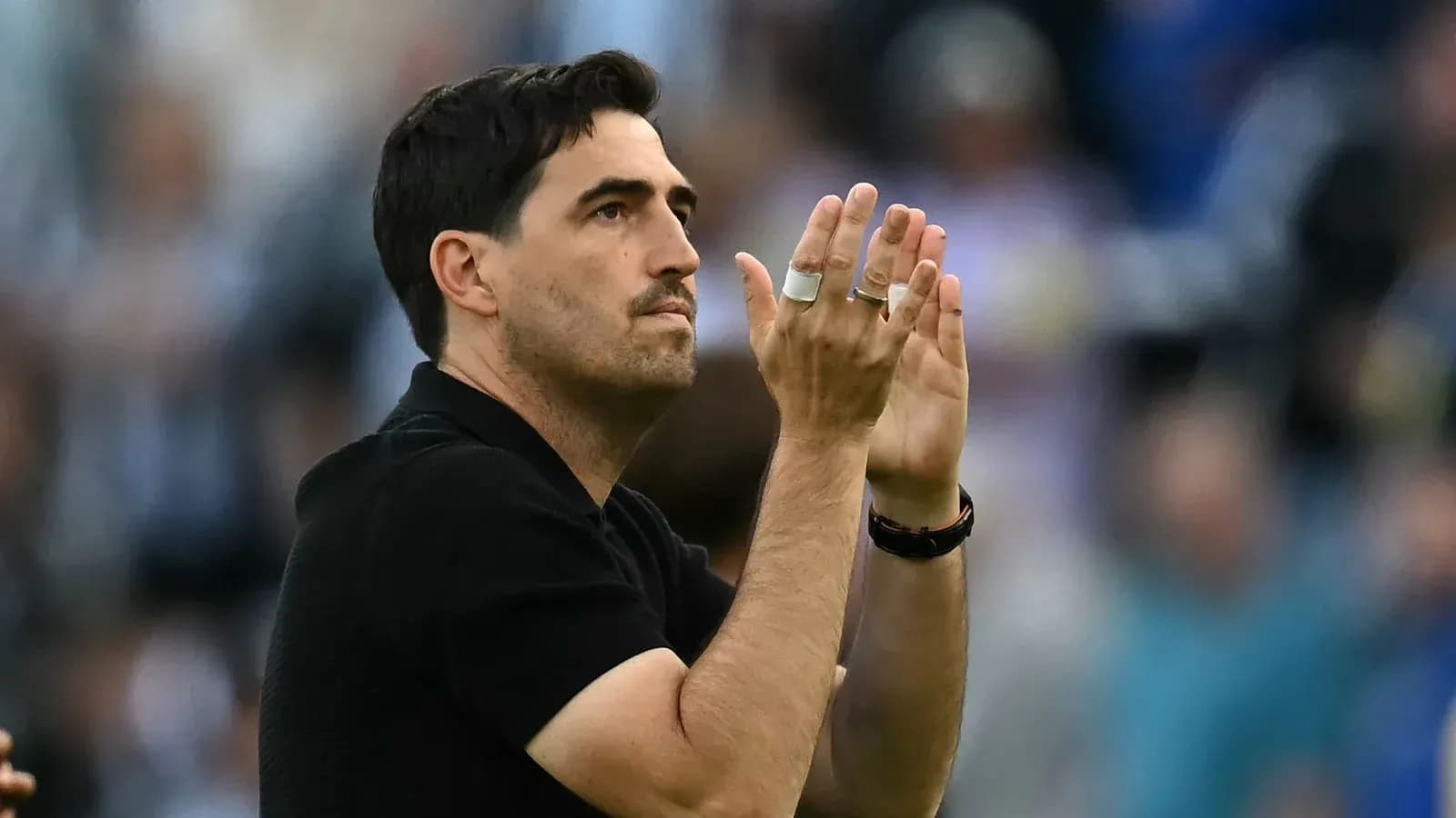 Coach applauding fans in the stadium