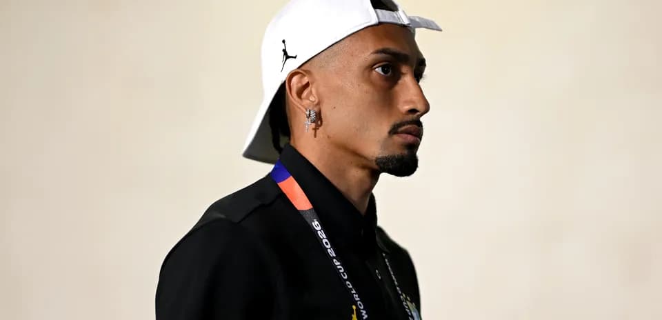 Person wearing cap and black shirt with lanyard