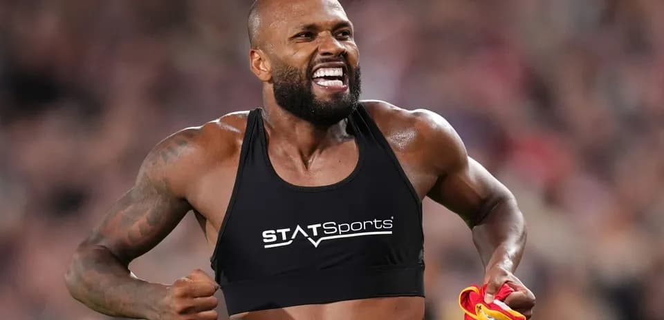 Athlete celebrating with jersey in hand during match