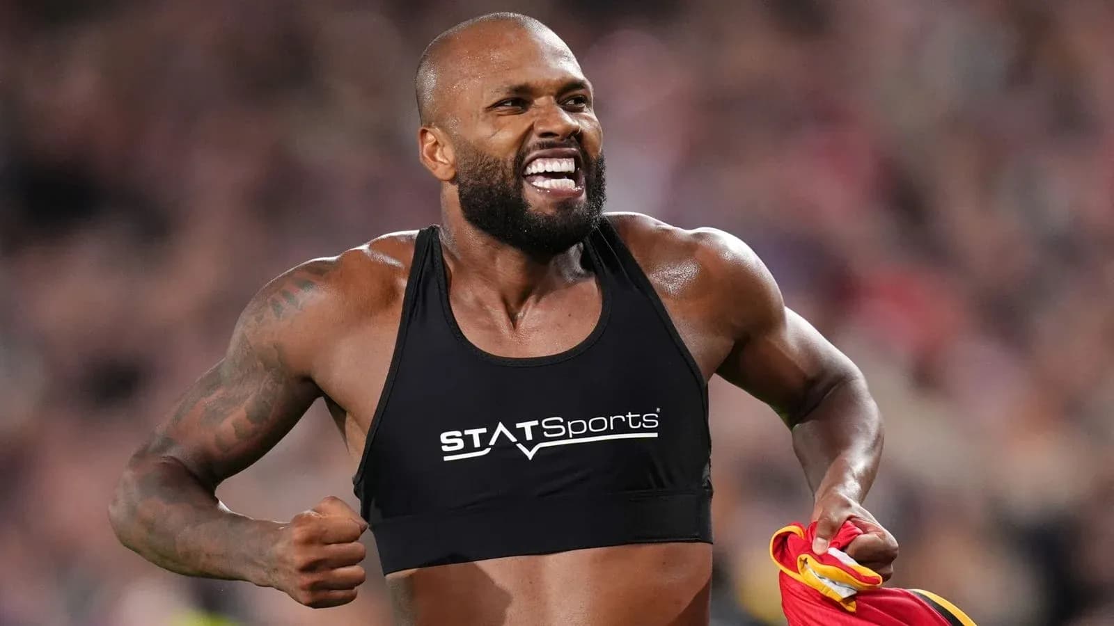 Athlete celebrating with jersey in hand during match