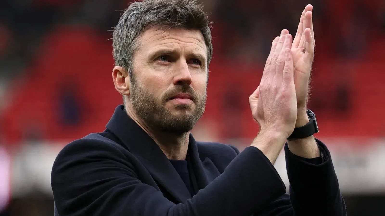 Coach applauding fans after the match
