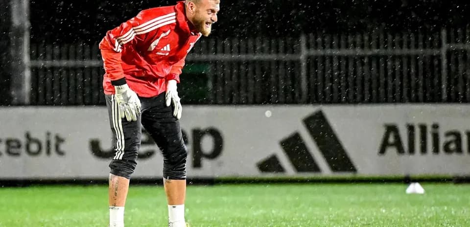 Goalkeeper training in the rain during practice session