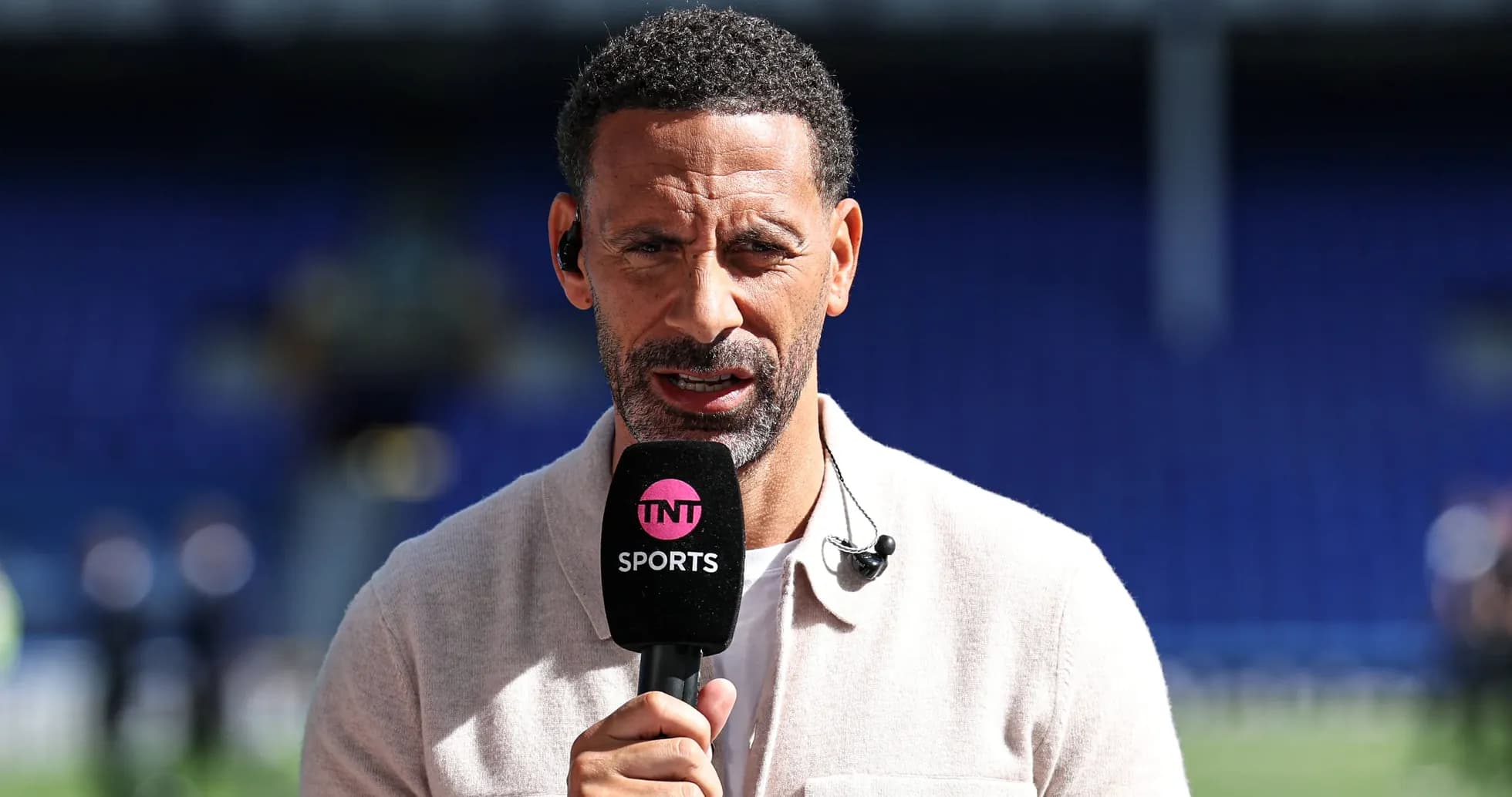 Analyst speaking into microphone during sports broadcast