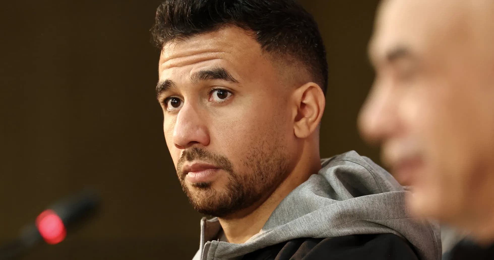 Athlete at press conference with microphone in foreground