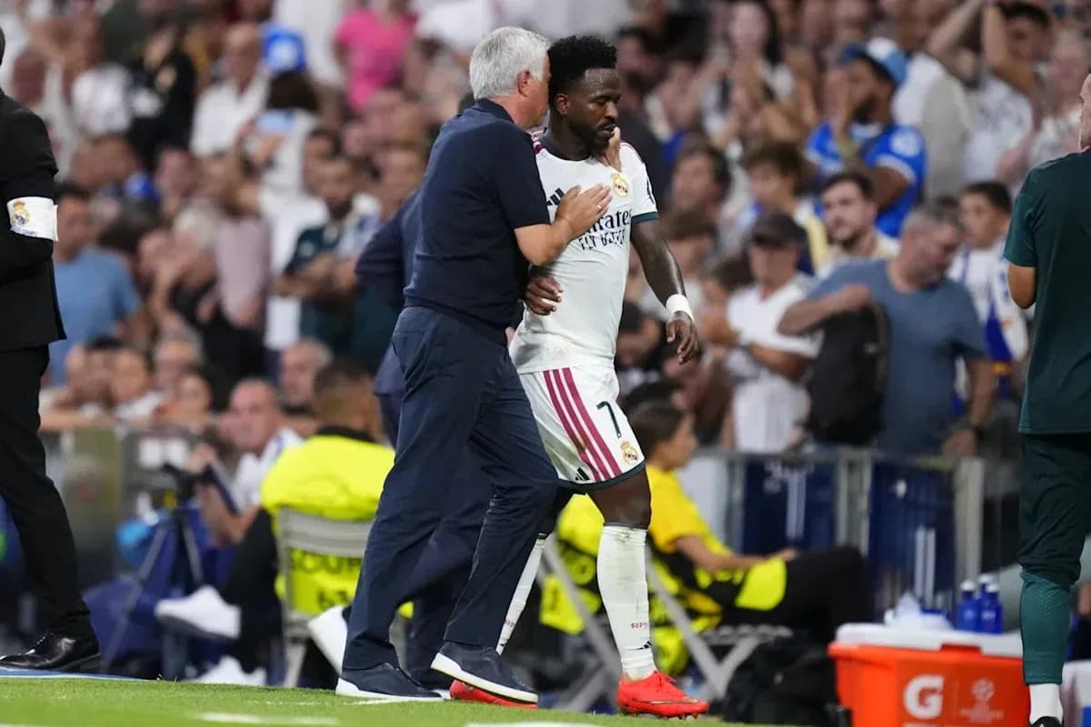 Vinícius Júnior leaving the pitch with coach Carlo Ancelotti