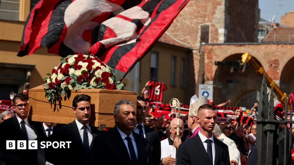 Funeral procession with coffin and supporters holding flags