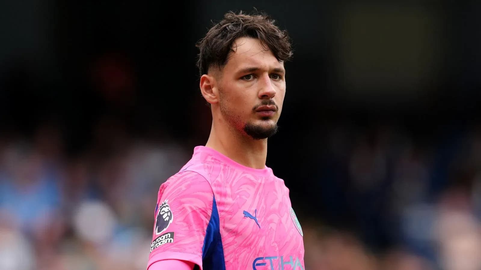 Goalkeeper in pink kit during match