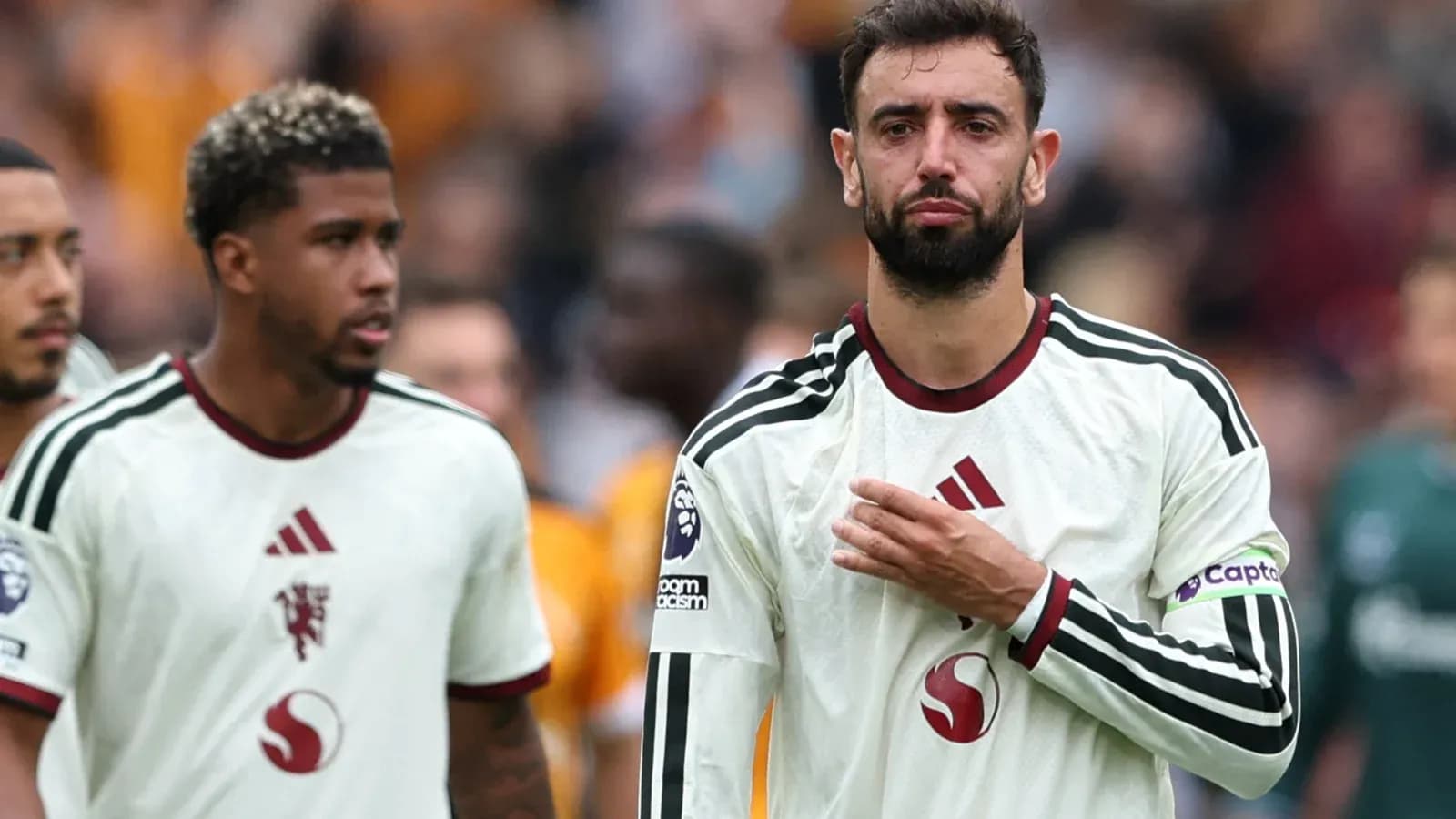 Bruno Fernandes and teammate walking off the pitch