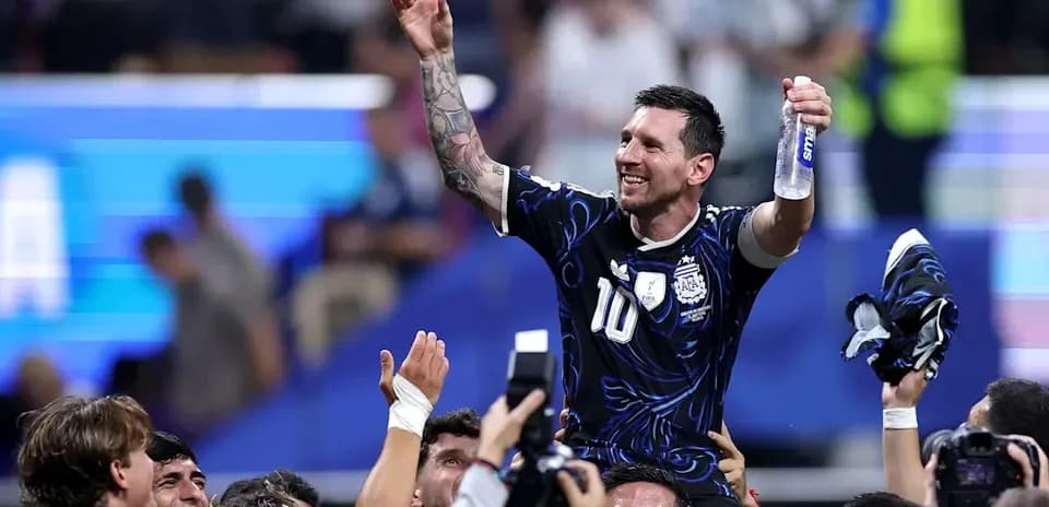 Lionel Messi celebrated by teammates after victory