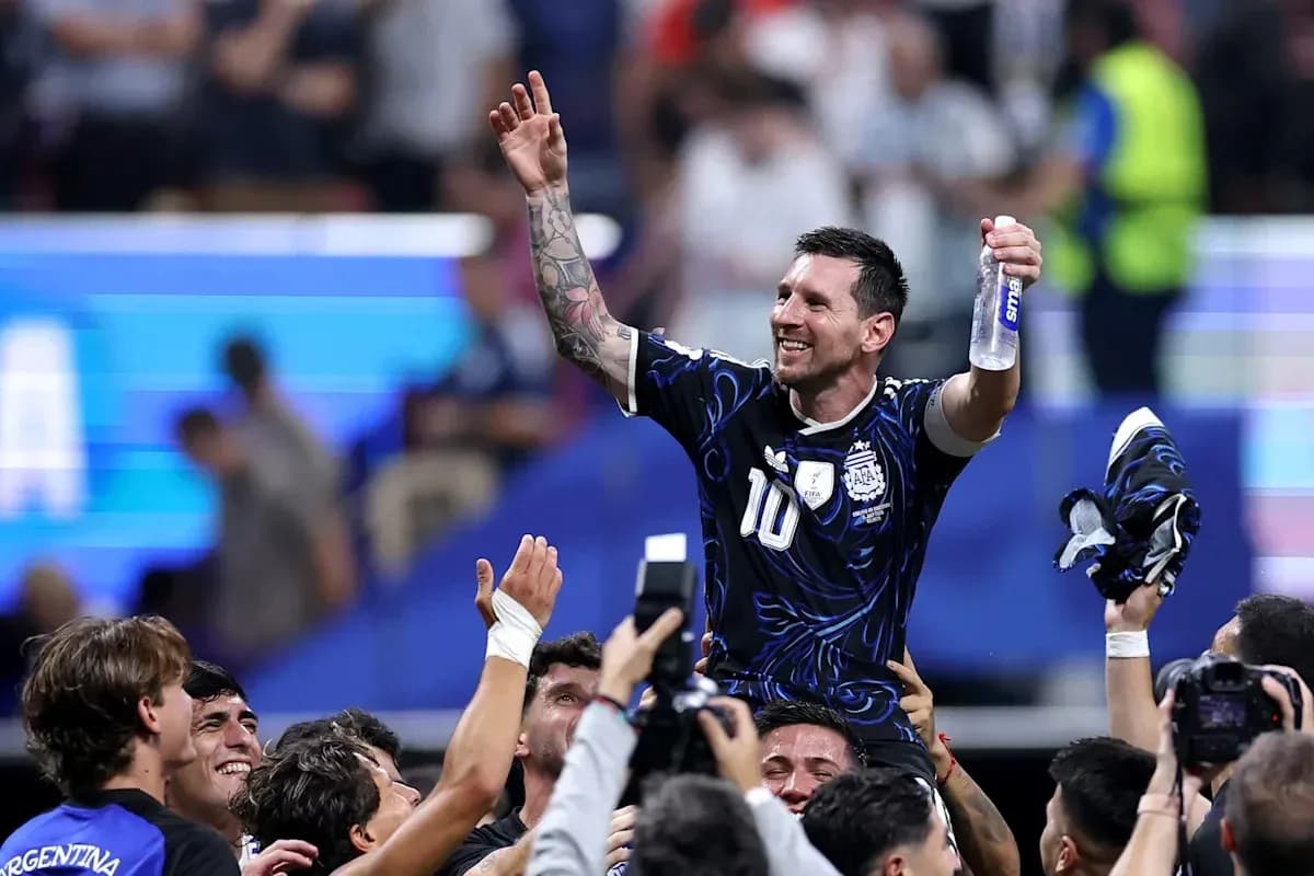 Lionel Messi celebrated by teammates after victory