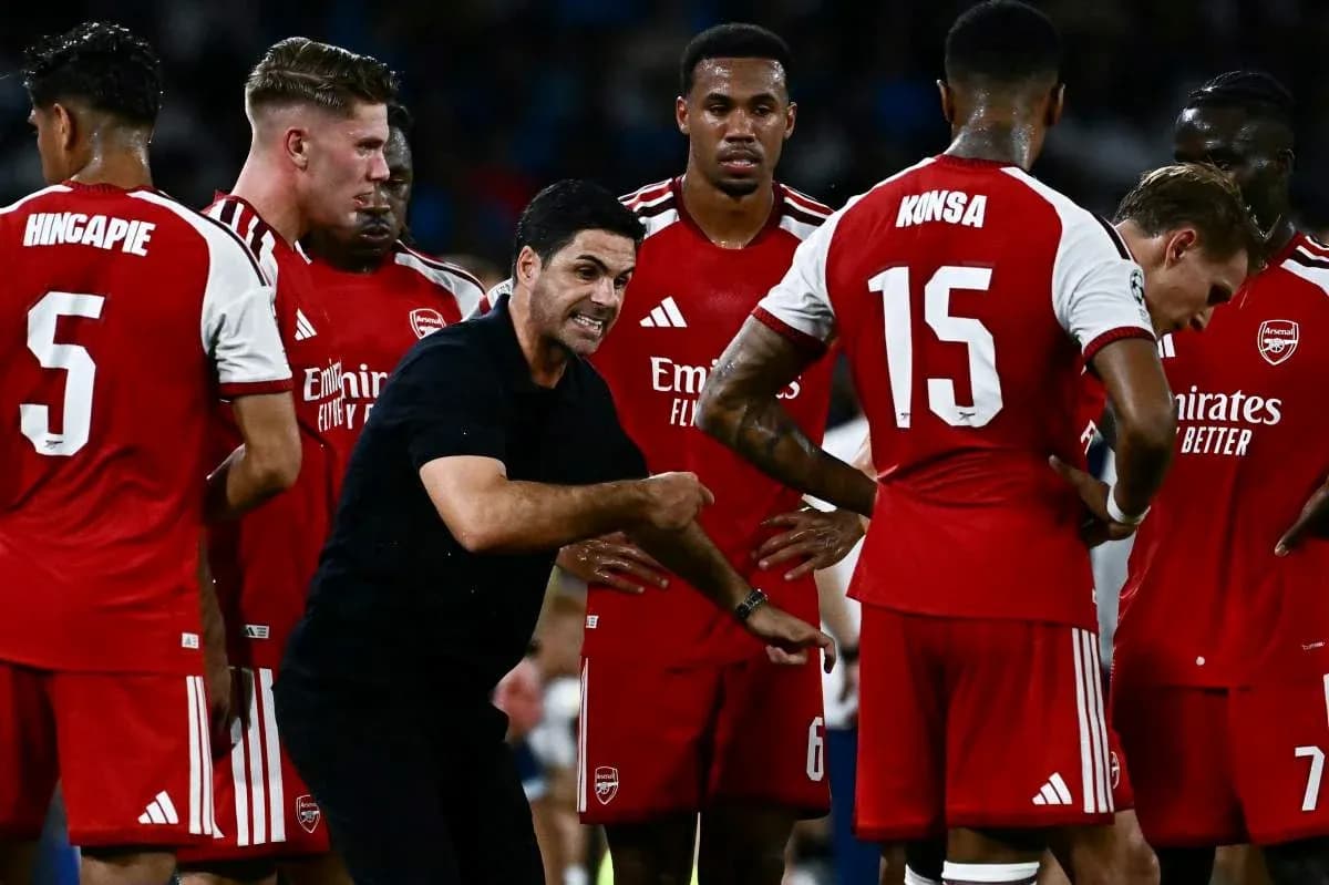 Arsenal players and coach discussing strategy during match