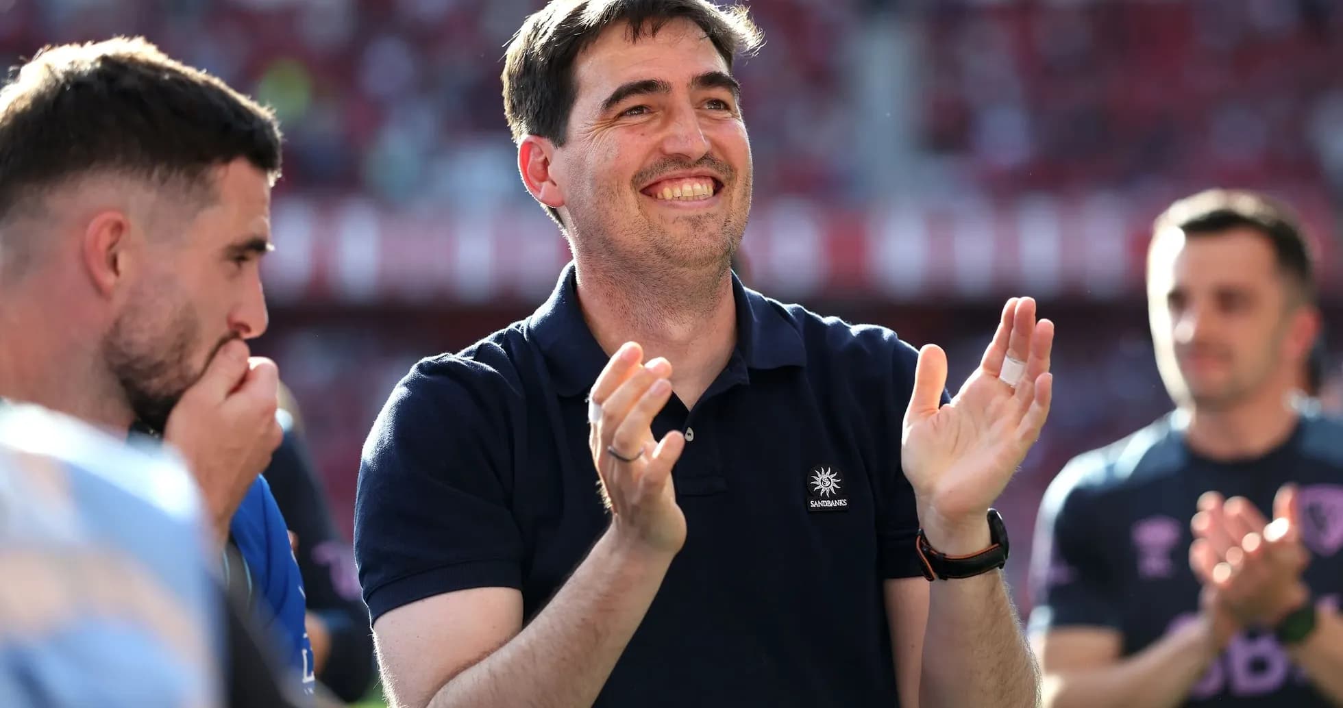 Coach applauding with players during match celebration