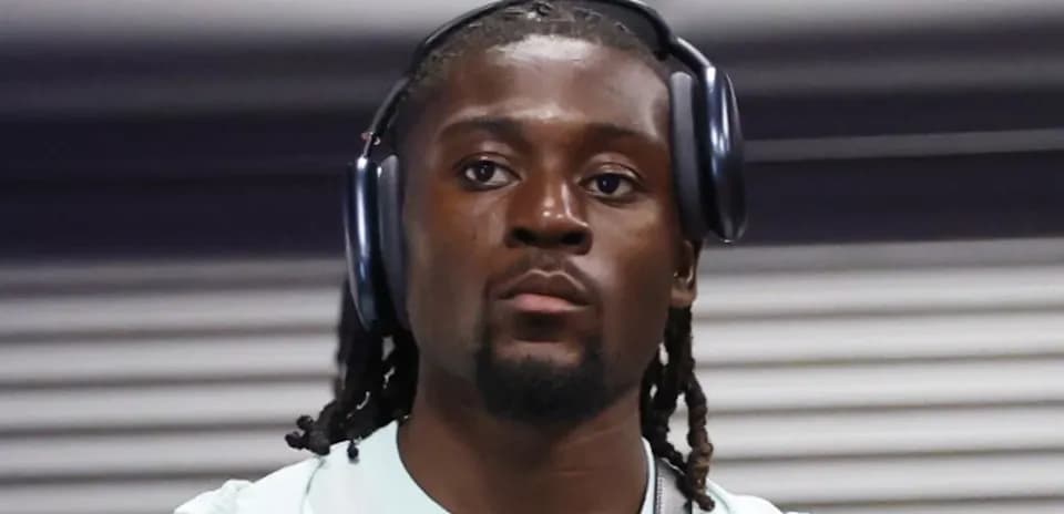 Athlete wearing headphones, focused and walking