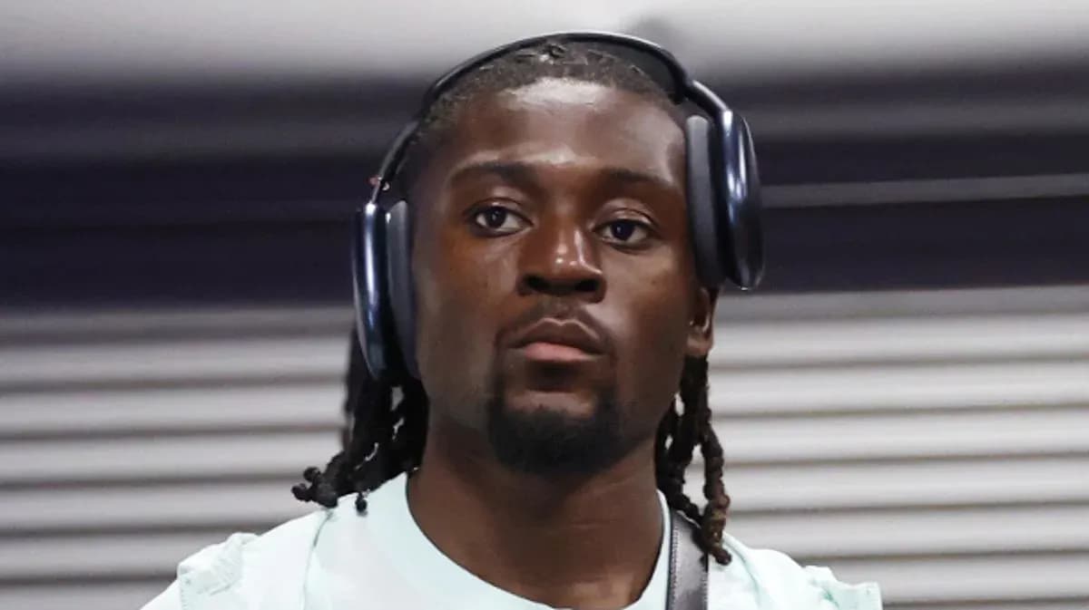 Athlete wearing headphones, focused and walking