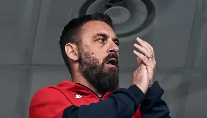 Bearded man applauding from a sports venue