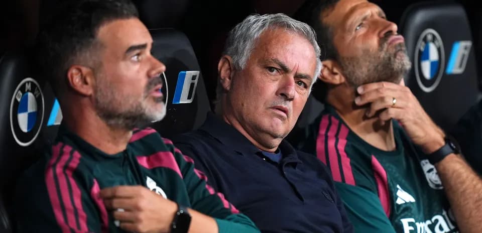 Coaches sitting on bench during a match