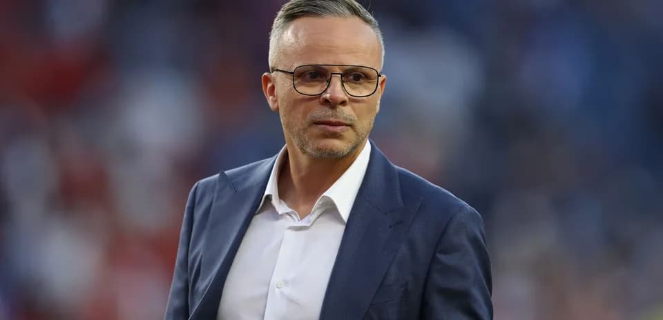 Men's football coach on the sidelines during match