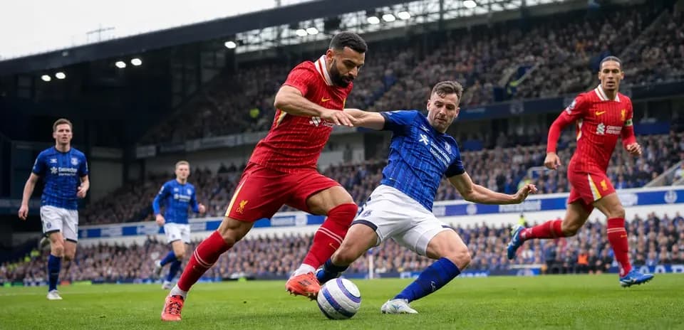 Liverpool and Everton players competing for the ball
