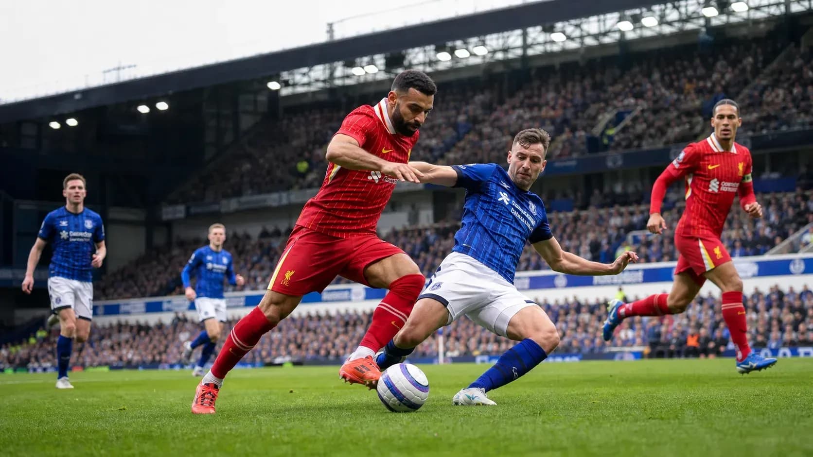 Liverpool and Everton players competing for the ball