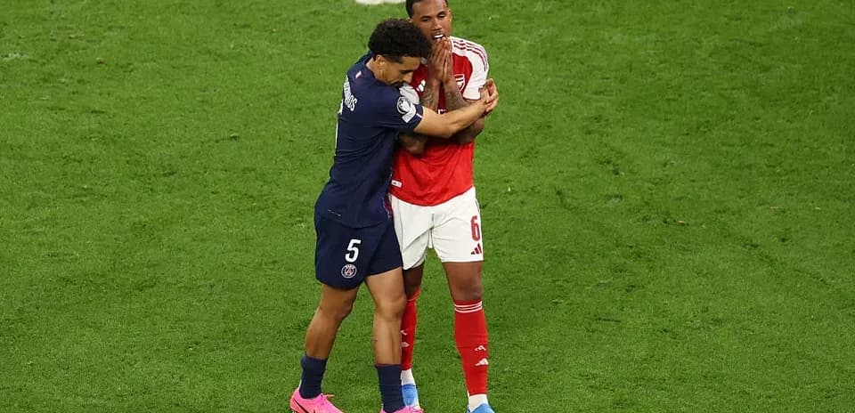 Two players embracing on the football field