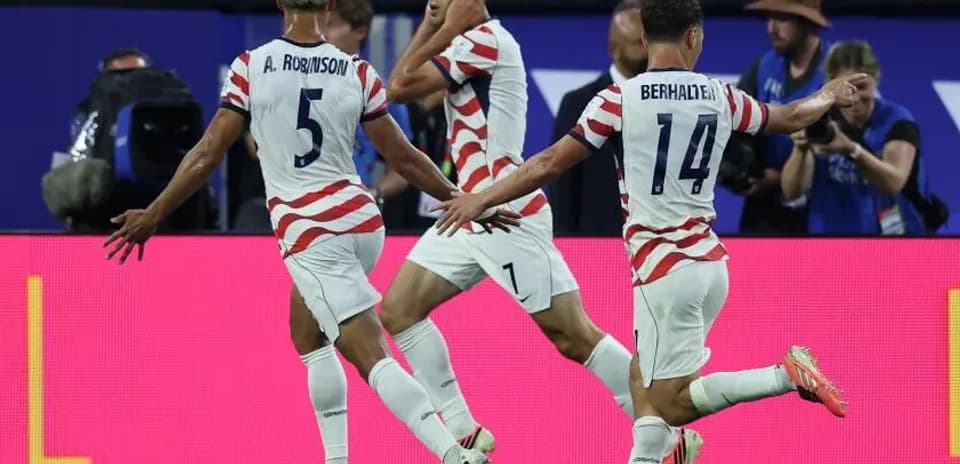 US players celebrating a goal during the match
