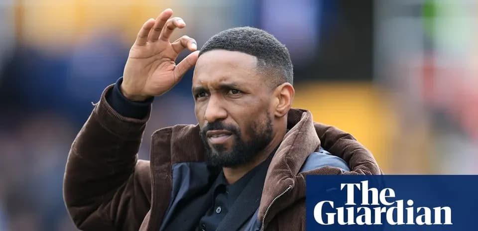 Football coach gesturing during match on field