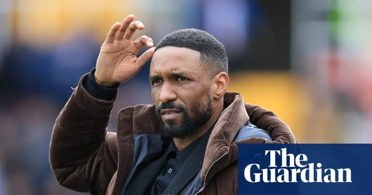 Football coach gesturing during match on field