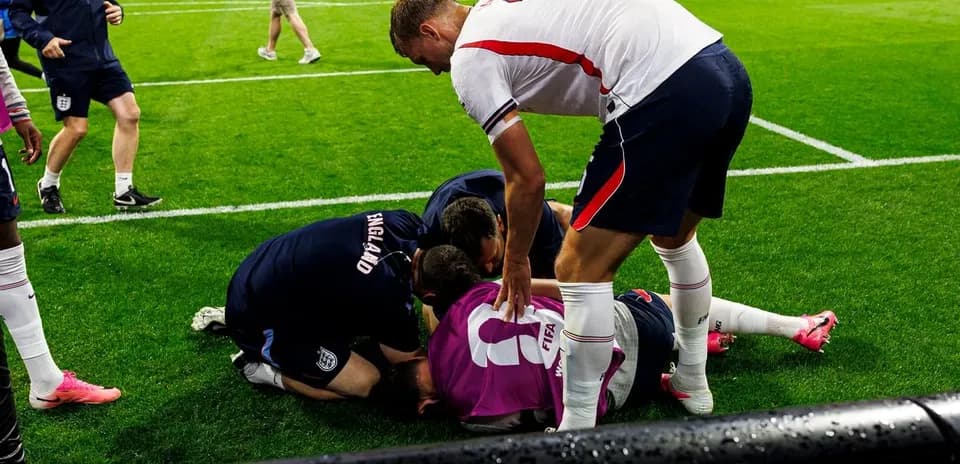 Players and staff attending to an injured teammate